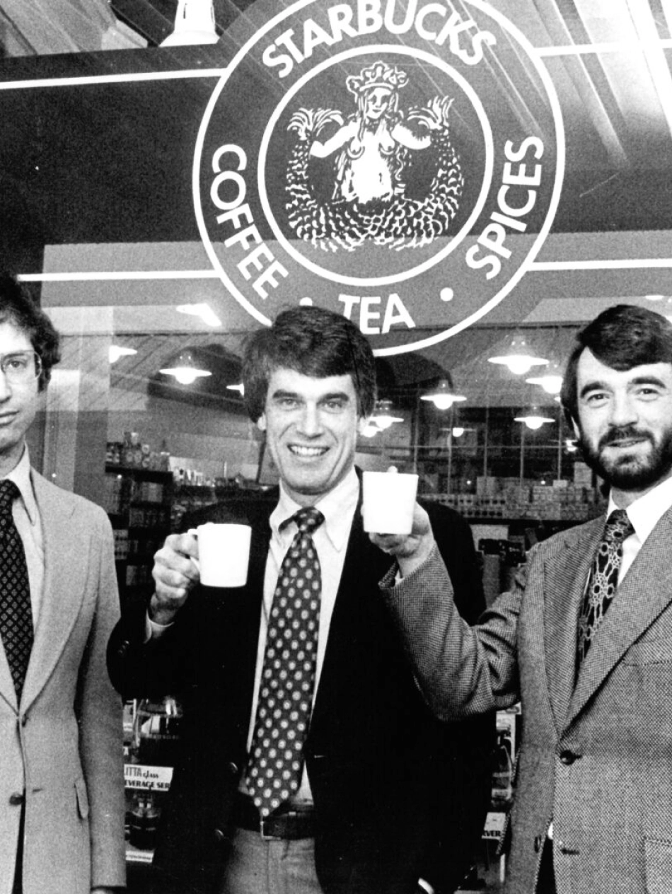 starbucks founder holding coffee outside starbucks store in 1979